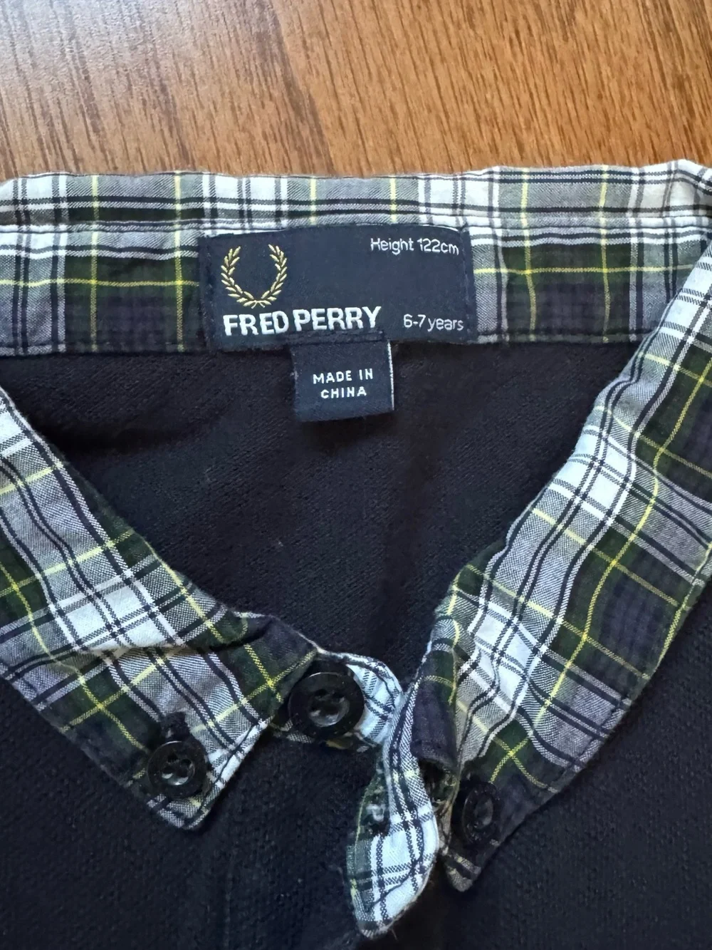 Fred Perry black polo shirt with plaid collar and sleeve cuffs, size 6-7 years